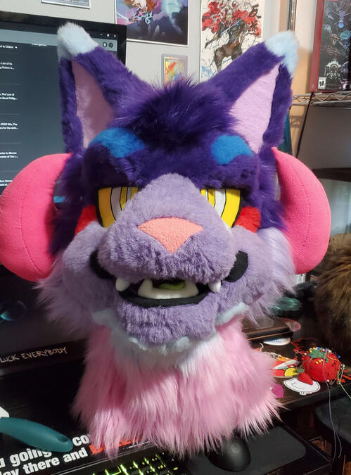BH1 The head of Bleeding Heart, a brightly colored cat beast with curled pink horns.