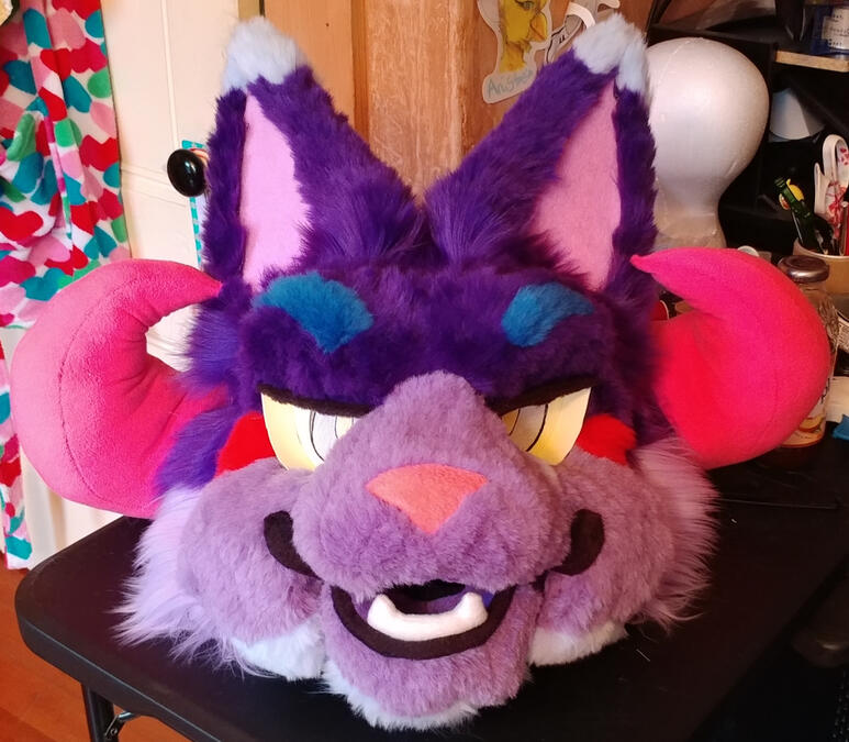 bh4 The head of Bleeding Heart, a brightly colored cat beast with curled pink horns.