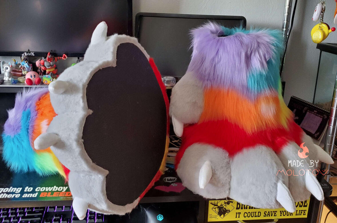 quartz3 The rainbow colored feet paws of Quartz. The foot on the left of the image is turned on its side, showing the foam padding on the bottom.